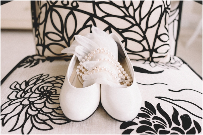 Detail shot of bridal shoes and necklace