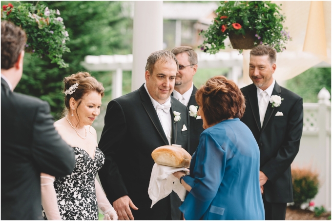 Groom's mother offers bread at Ceremony at French Creek Manor in Snohomish, WA