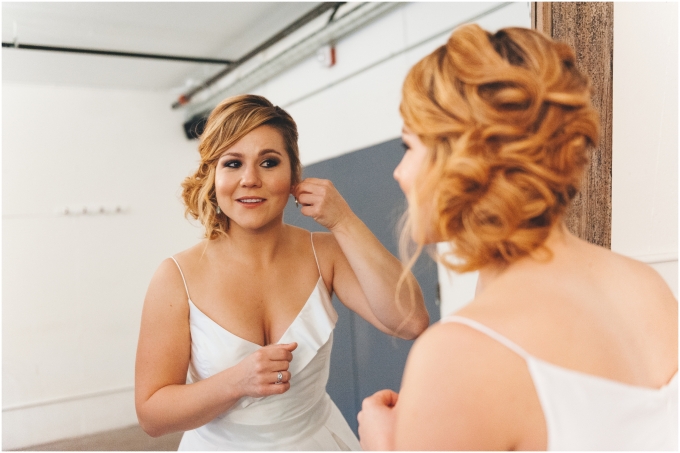 Bride getting ready at the Fremont Foundry in Seattle. Image captured by Ardita Kola Photography.