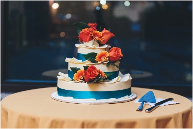 Orange and blue Wedding Cake at the Fremont Foundry in Seattle. Image captured by Ardita Kola Photography.