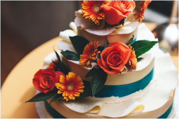 Orange and blue Wedding Cake at the Fremont Foundry in Seattle. Image captured by Ardita Kola Photography.
