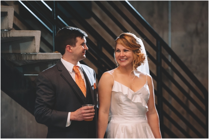 Bride and groom laughing during the toasts at the Fremont Foundry in Seattle. Image captured by Ardita Kola Photography.