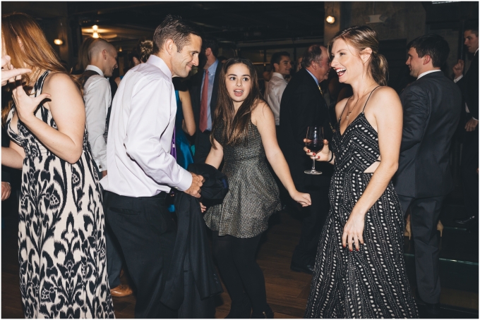 Guests dancing during wedding reception at the Fremont Foundry in Seattle. Image captured by Ardita Kola Photography.