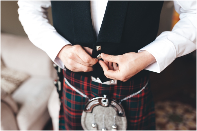 Photo of groom putting on his scottish attire and details for Scottish American wedding captured by Ardita Kola Photography