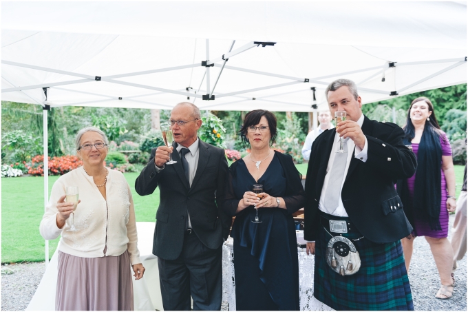 Photo of guests enjoying cocktail hour at a Scottish American Wedding @ Glen Echo Gardens in Bellingham, WA captured by Ardita Kola Photography