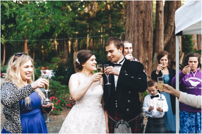 Photo of bride and groom enjoying cocktail hour at a Scottish American Wedding @ Glen Echo Gardens in Bellingham, WA captured by Ardita Kola Photography